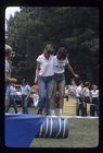 Two students balancing on a barrel 
